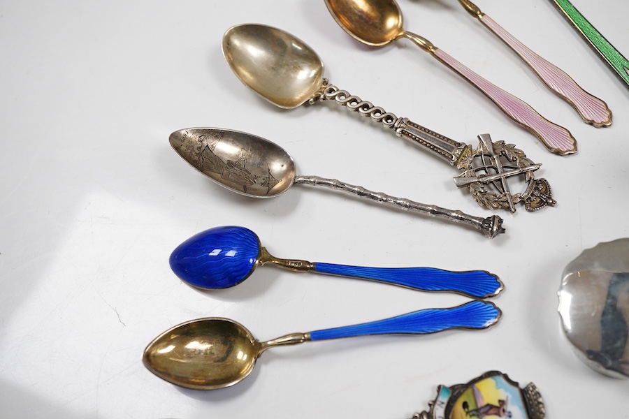 Assorted silverware including a late Victorian mother of pearl handled butter knife, a George V pill box, an Edwardian mustard pot with plated spoon, two enamelled golf related spoons, a rifle shooting related spoon, six